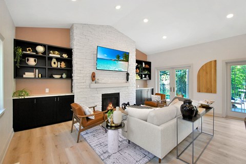 a living room with a white couch and a fireplace