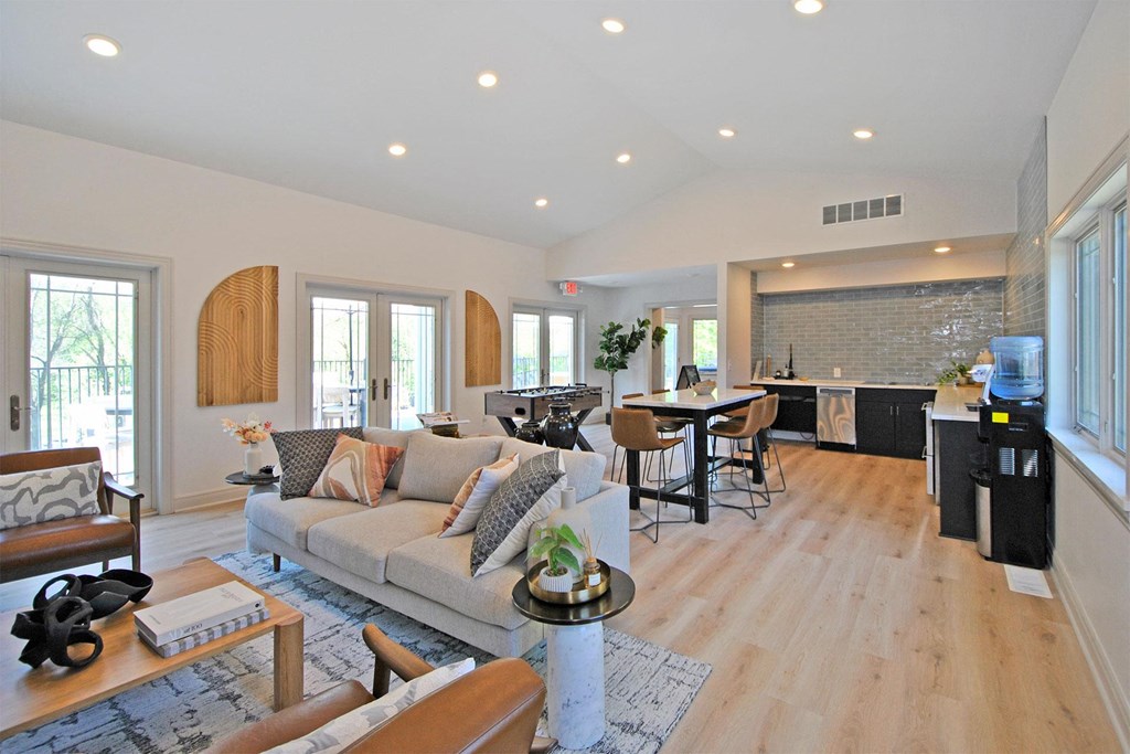 a living room with a couch and a kitchen with a table and chairs