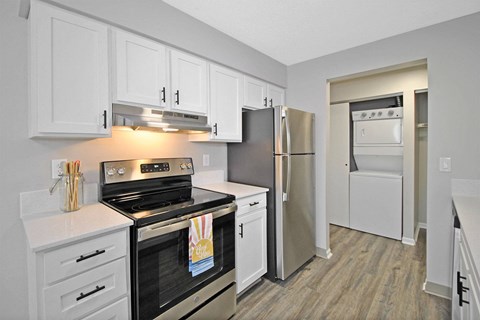 a kitchen with stainless steel appliances and white cabinets