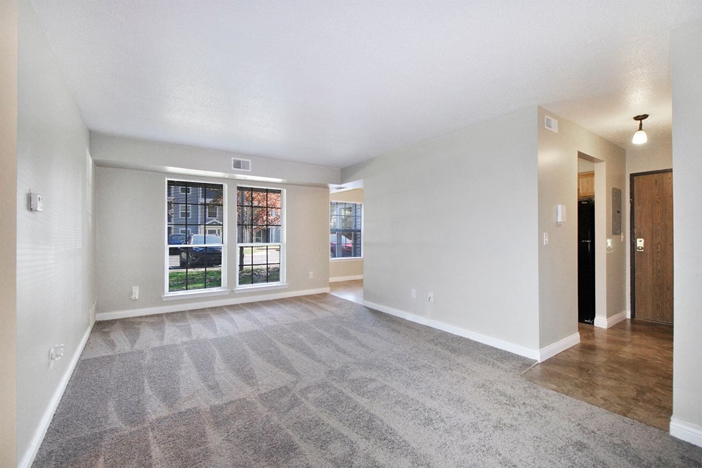 the spacious living room and dining room in a new home