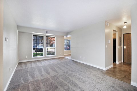 the spacious living room and dining room in a new home