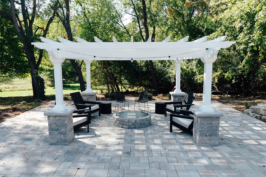 a patio with a pavilion and a fire pit