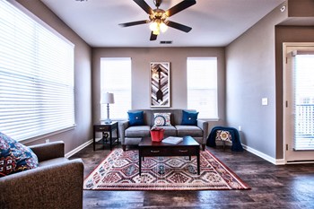 Goshen Apartments - Park Thirty-Three - Living Area with Wood-Style Flooring and Ceiling Fan - Photo Gallery 6
