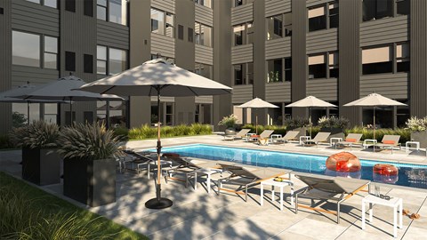 A pool area with chairs and umbrellas in front of a building.