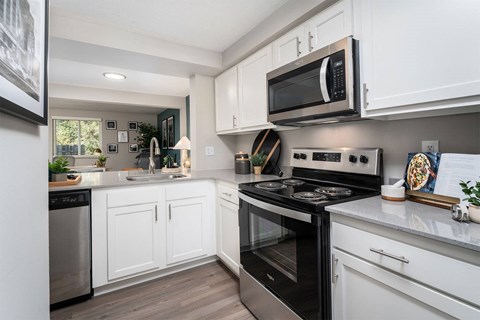 a kitchen with stainless steel appliances and white cabinets