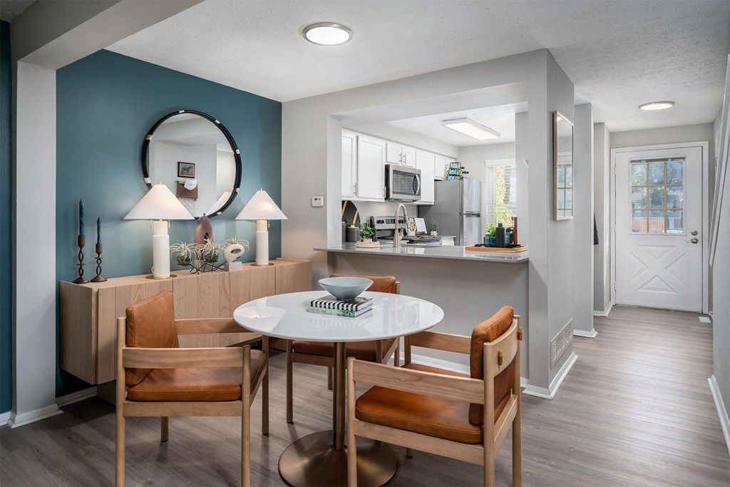 a dining room and kitchen with a table and chairs