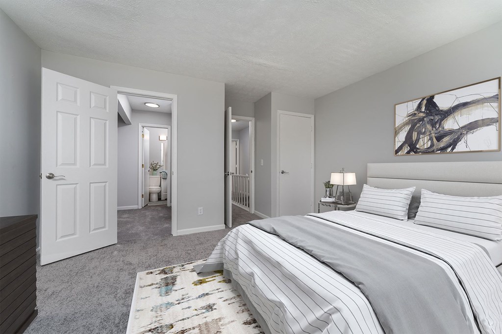 a bedroom with a large bed and a closet