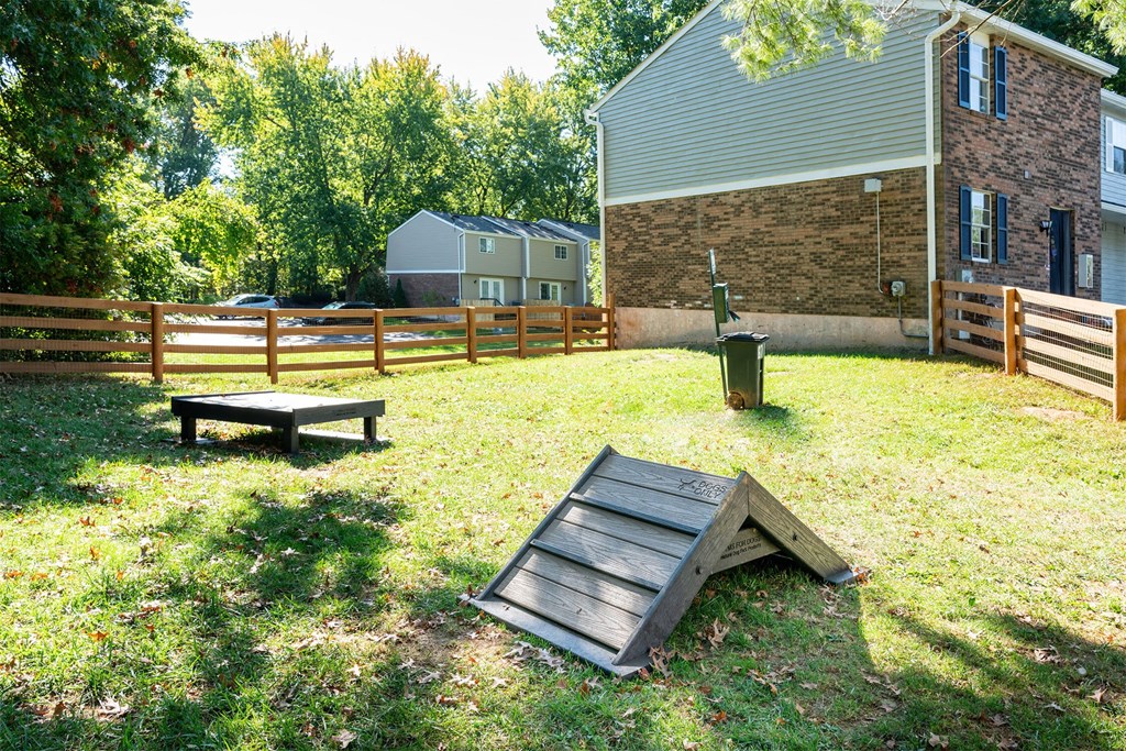 a backyard with a picnic table and a fence