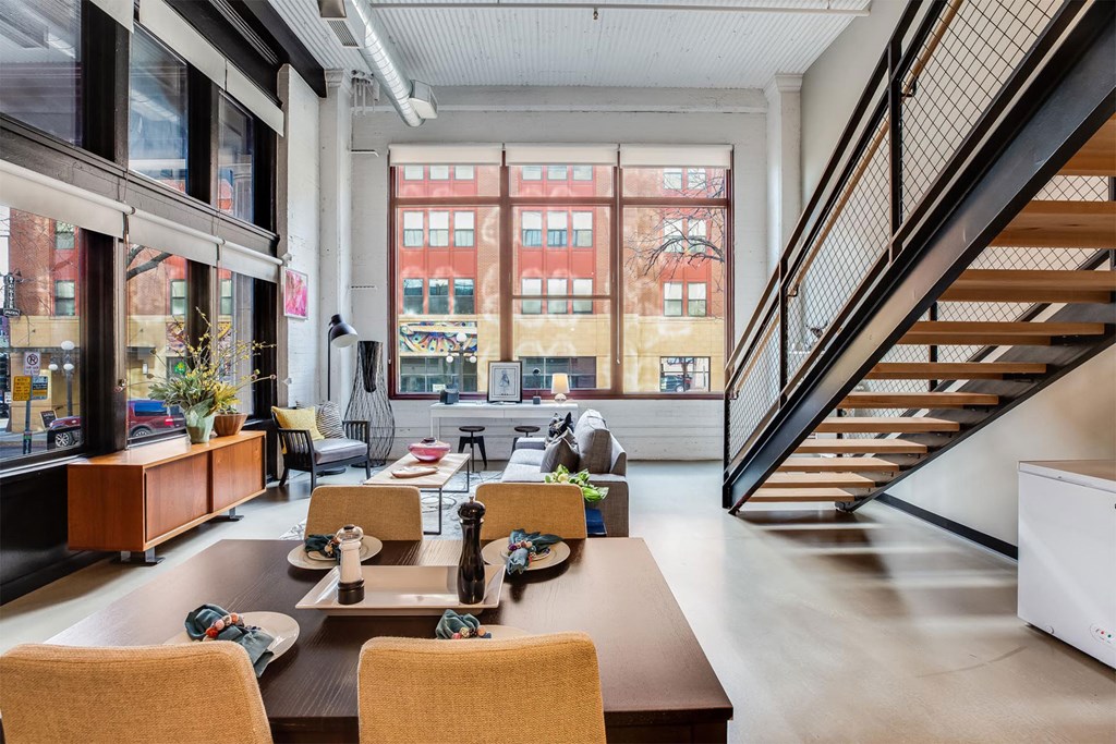 A modern dining room with a long table and chairs.