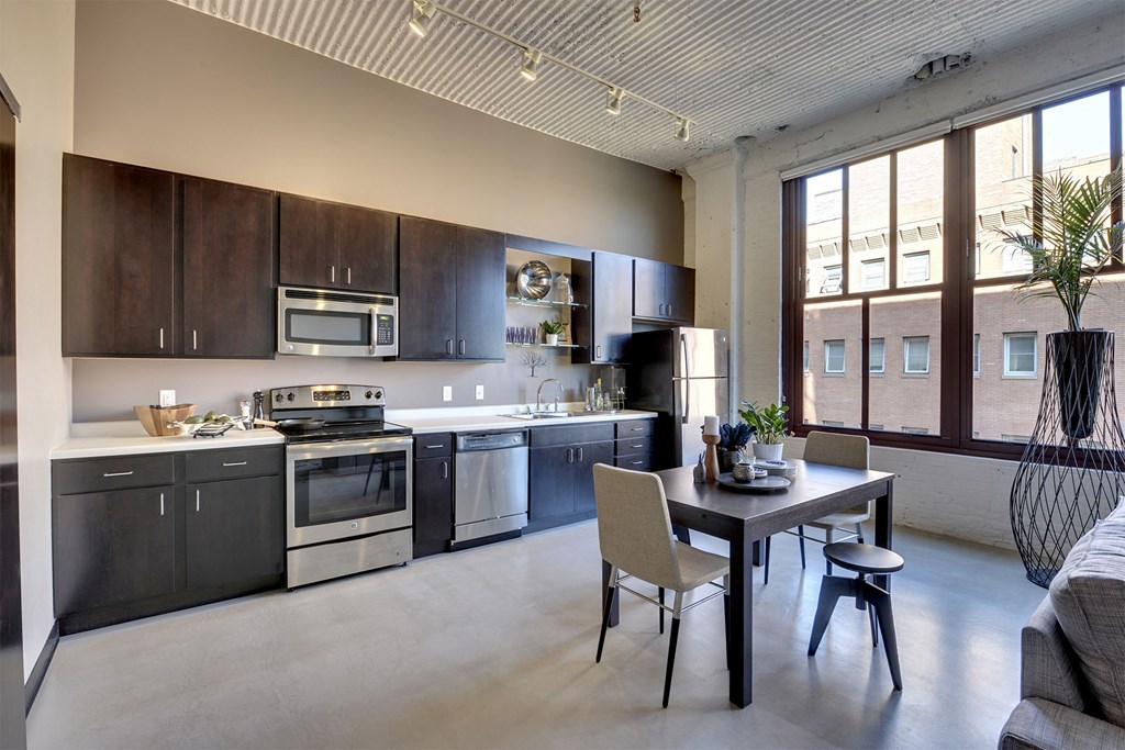 A modern kitchen with a dining table and chairs.