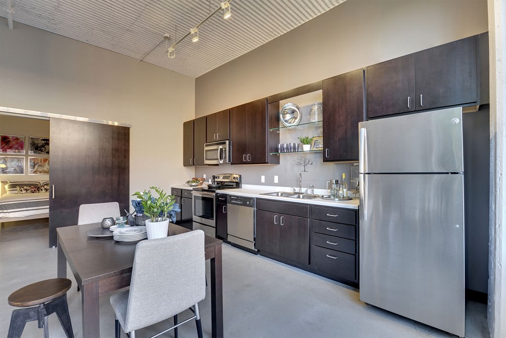A modern kitchen with a dining table and chairs.