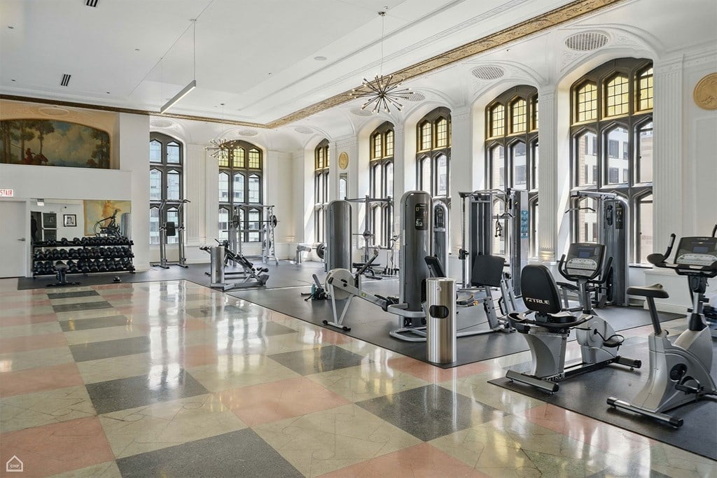 A gym with a variety of equipment and a checkered floor.