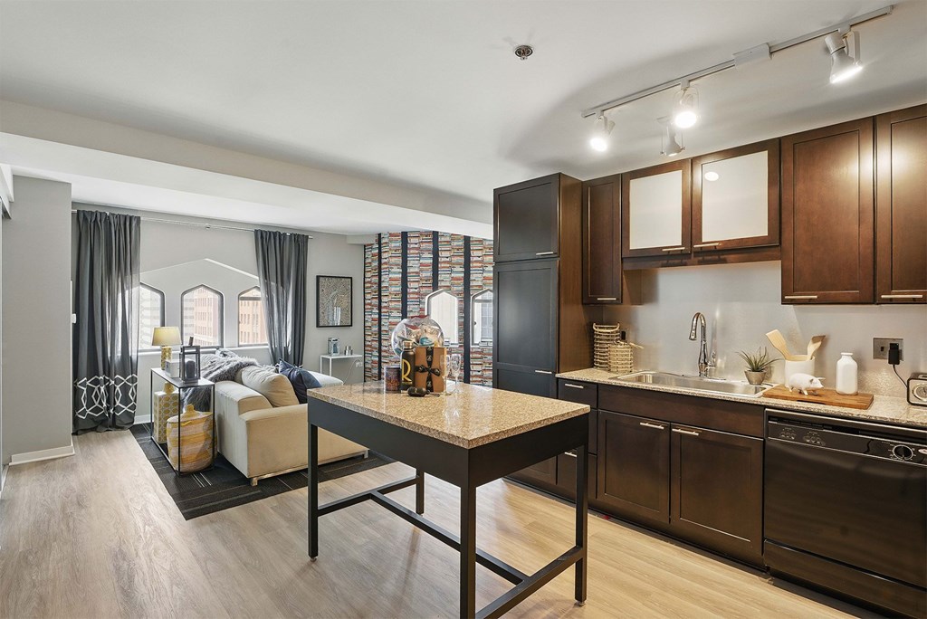A modern kitchen with dark wood cabinets and a central island.
