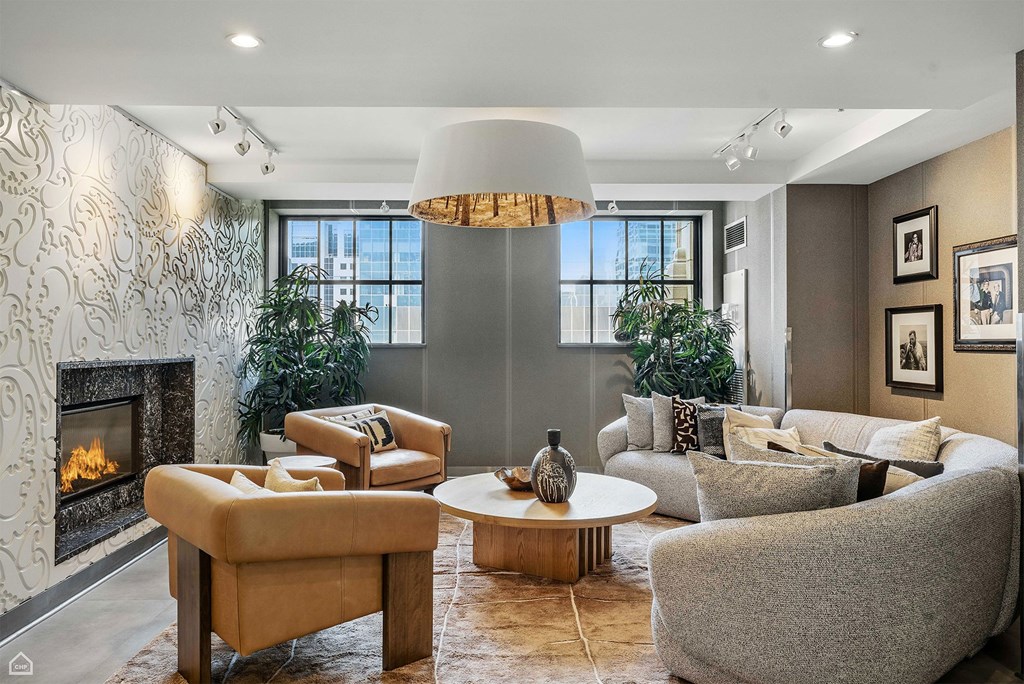 A living room with a fireplace and a large window.