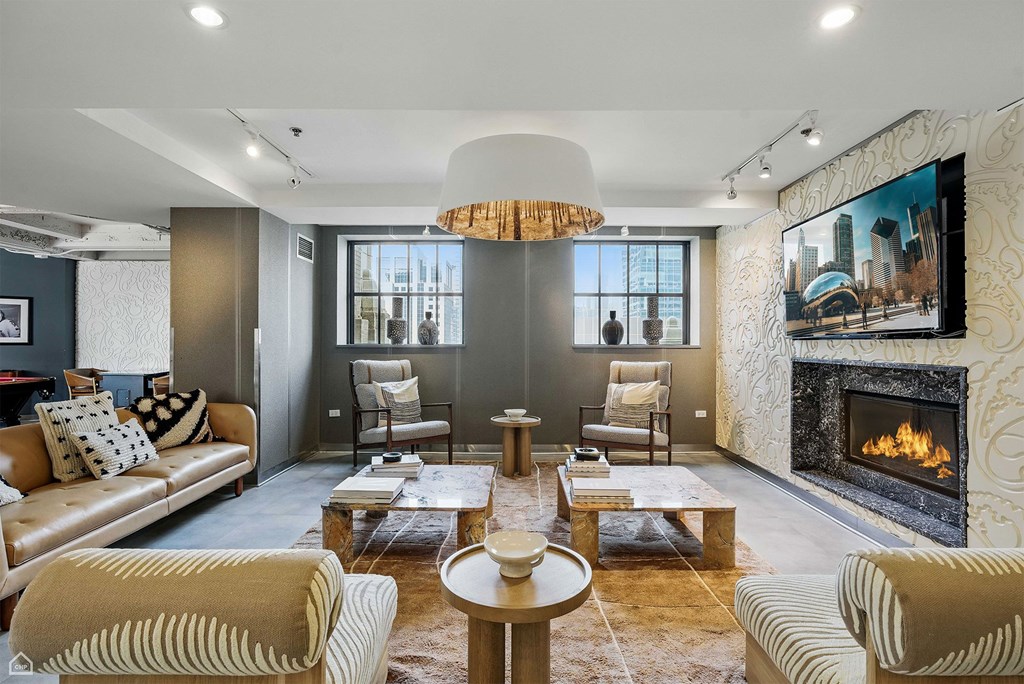 A modern living room with a fireplace and a television.