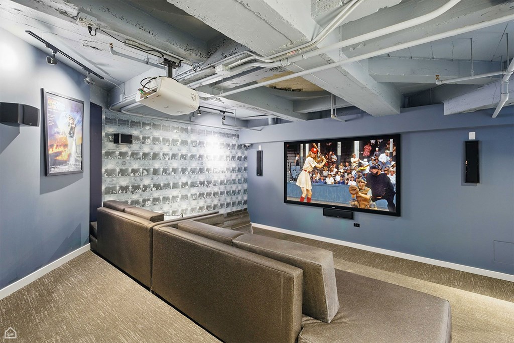 A modern living room with a large couch and a television.