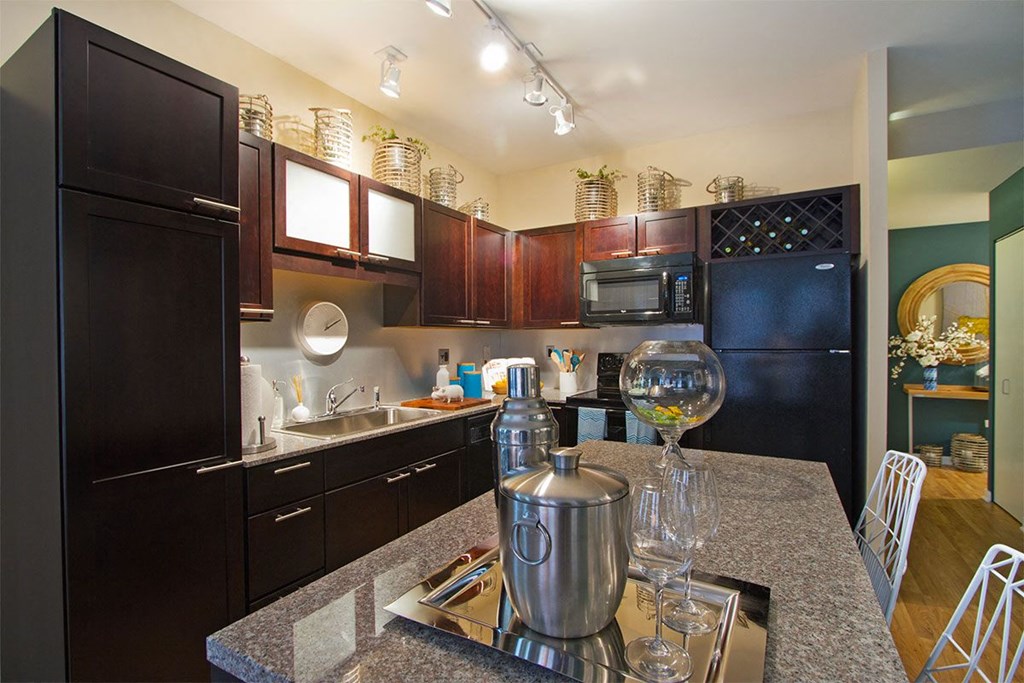 a kitchen with black appliances and granite counter tops