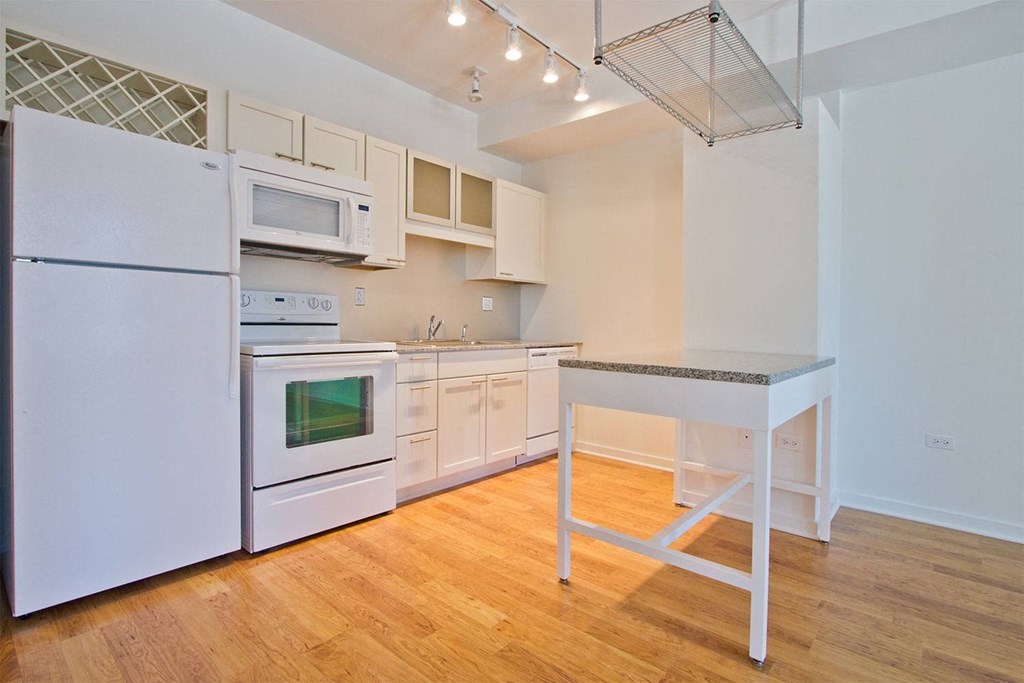 a kitchen with white appliances and a counter top