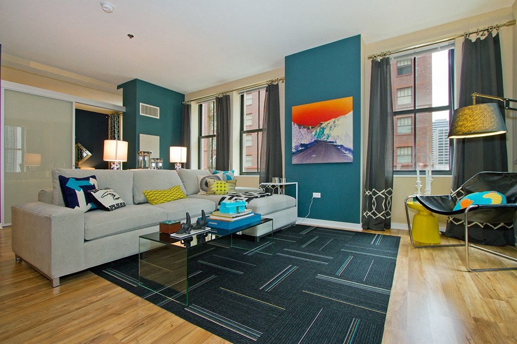 a living room with blue walls and a white couch