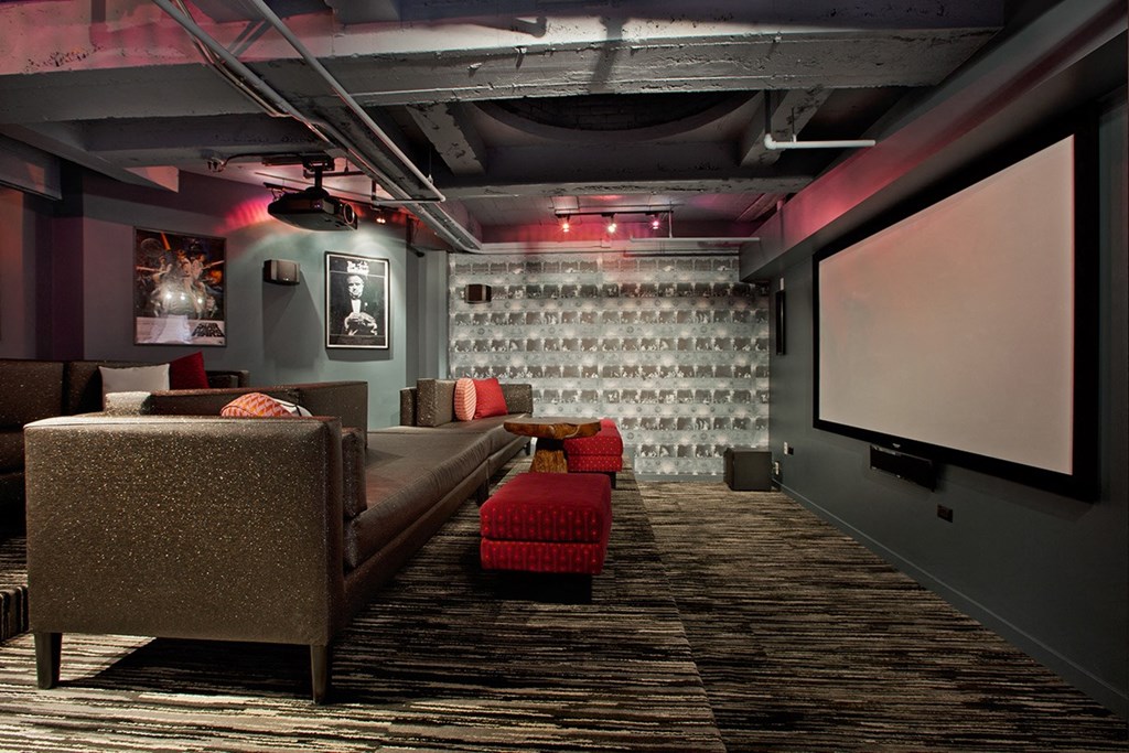 a large screening room with a couch and a projector