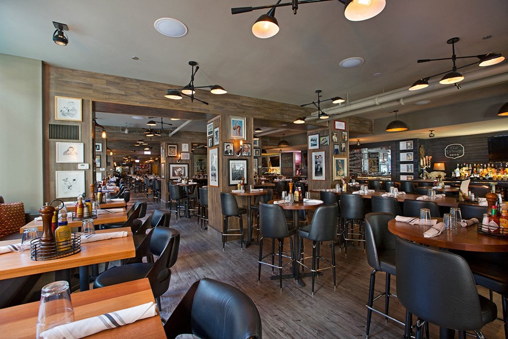 a dining room with tables and chairs and a bar