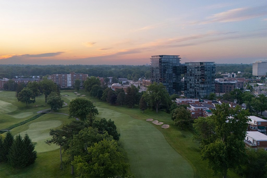 A golf course with a building in the background.