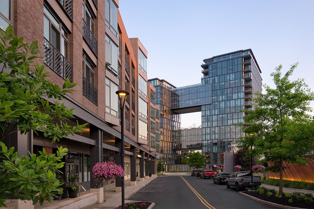 A street view of a modern building with a glass facade.