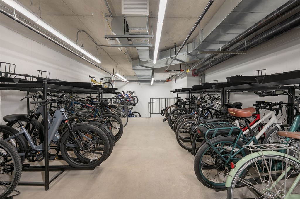 A bike rack with many bikes parked inside.