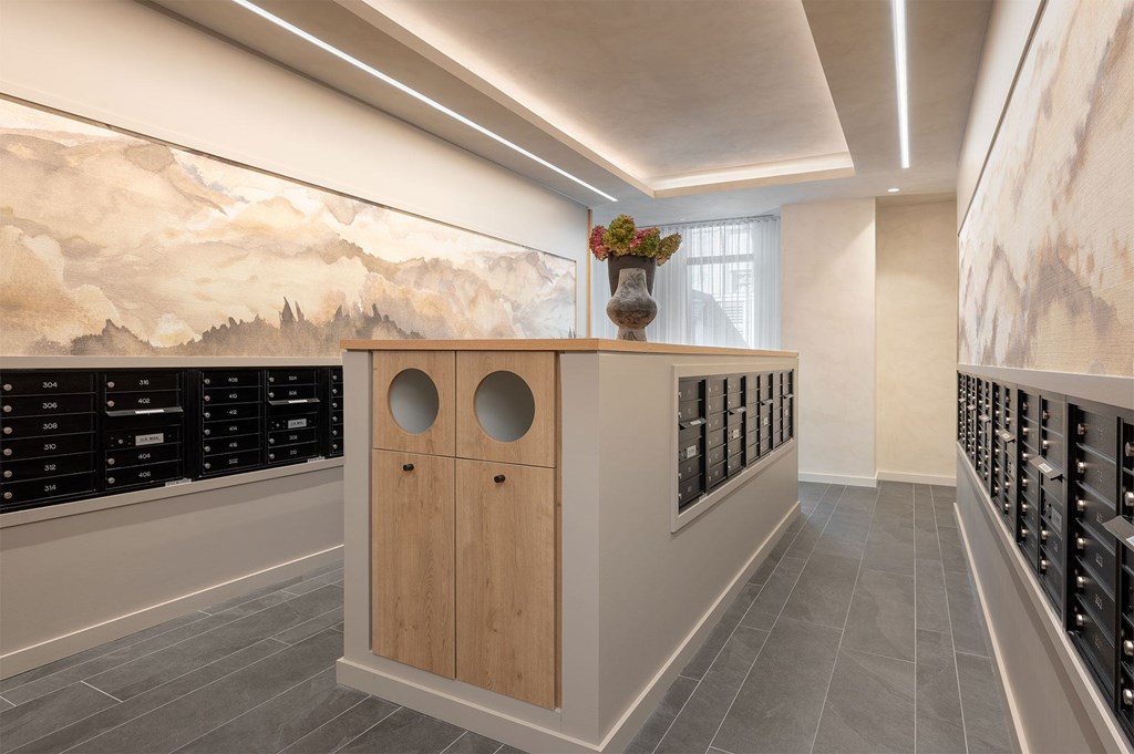 A room with a wooden cabinet and a vase of flowers on top.