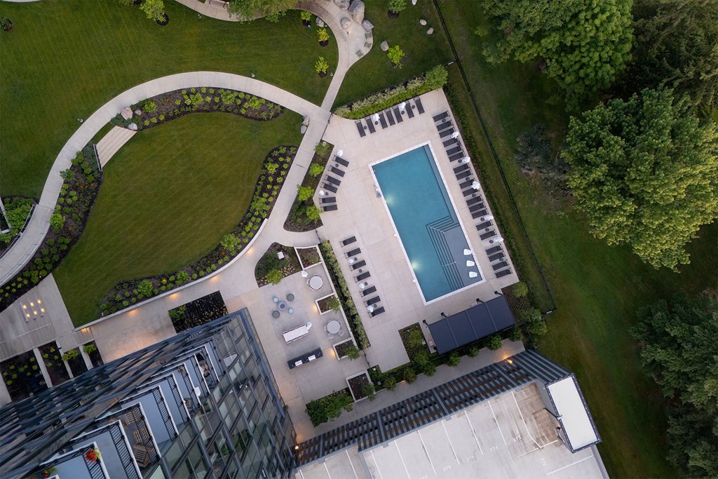 A bird's eye view of a residential area with a pool and a building.