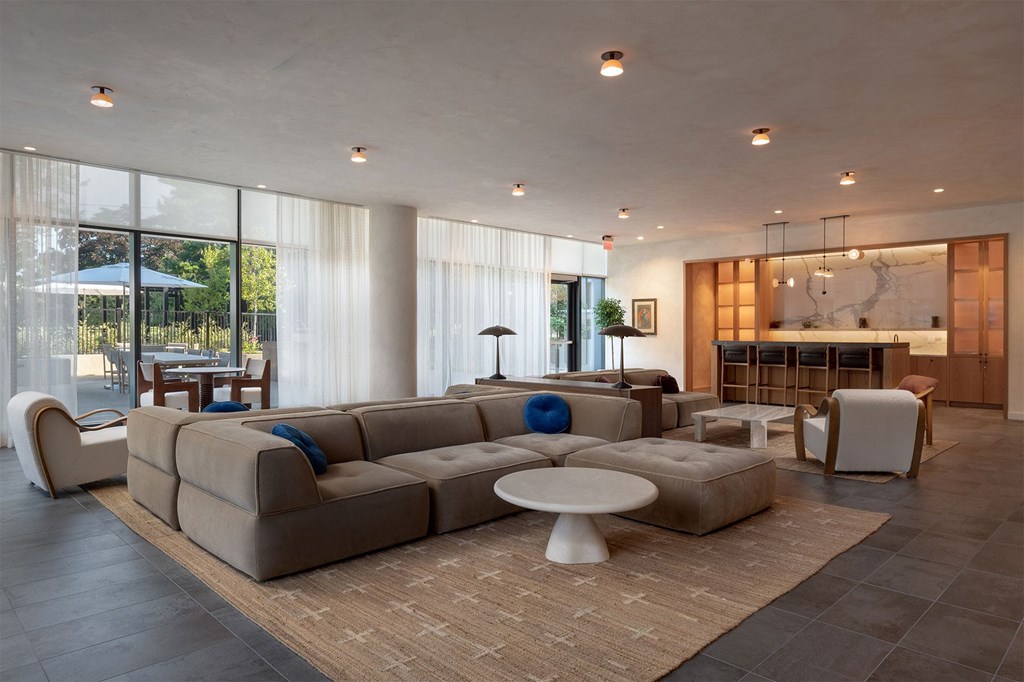 A modern living room with a large sectional sofa and a coffee table.