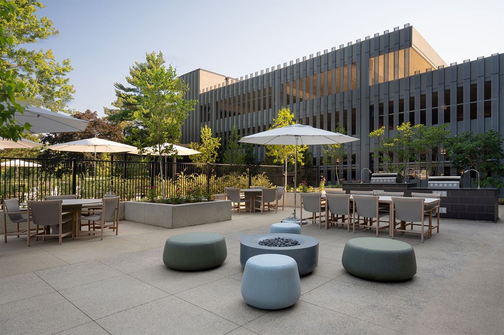 A modern outdoor seating area with tables and chairs.
