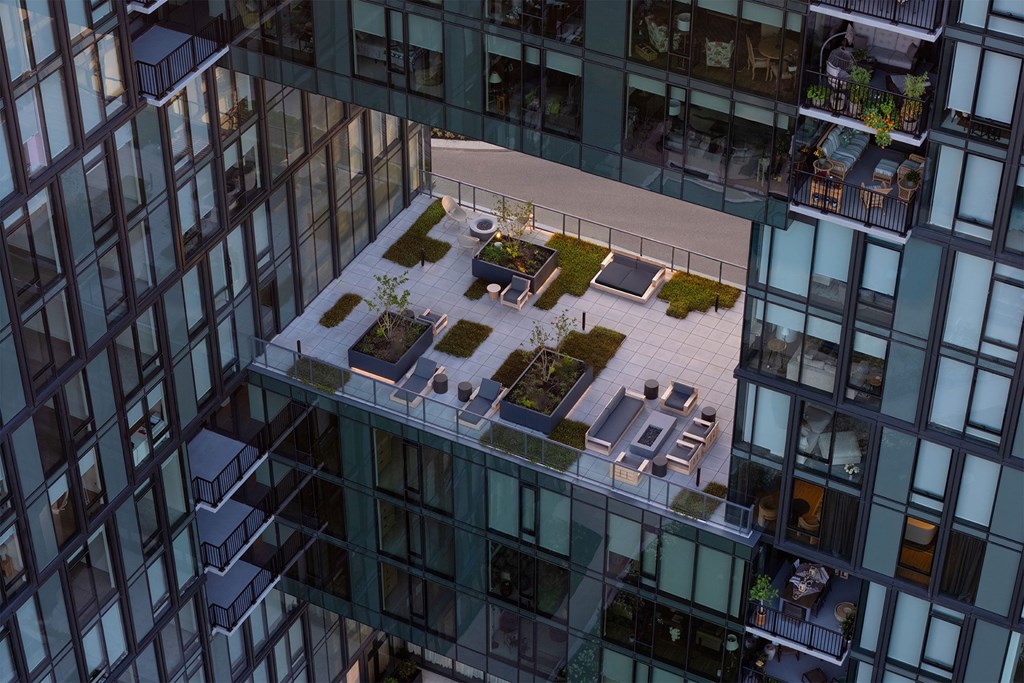 A modern glass building with a small courtyard in the middle.