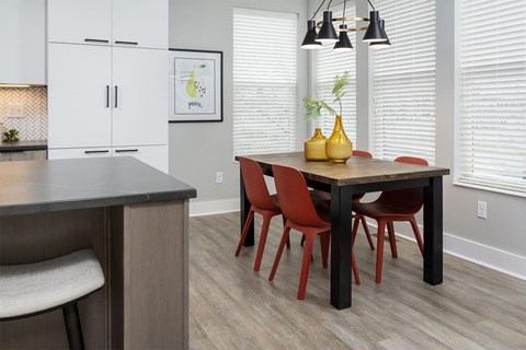 A kitchen with a table and chairs.