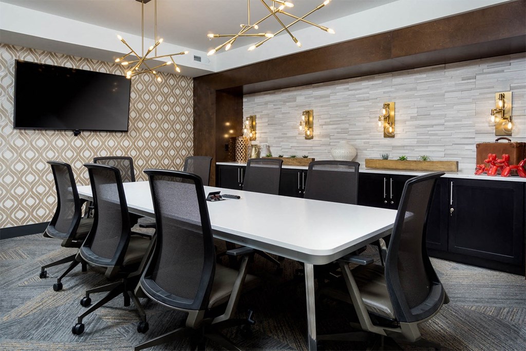 A conference room with a long table and chairs.