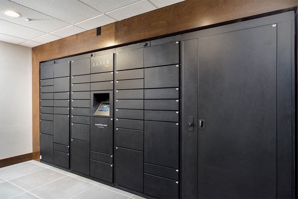 A row of black lockers with a sign that says "LUXE".
