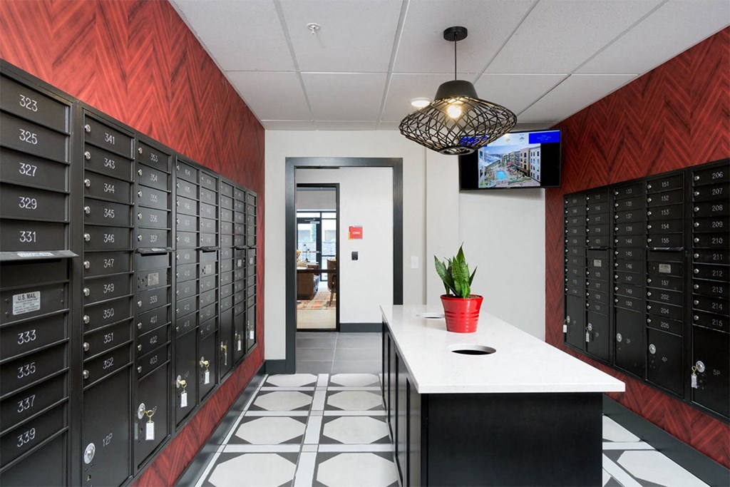 A row of mailboxes are lined up on a wall.
