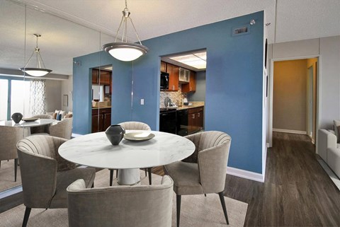 A dining room with a round table and chairs.