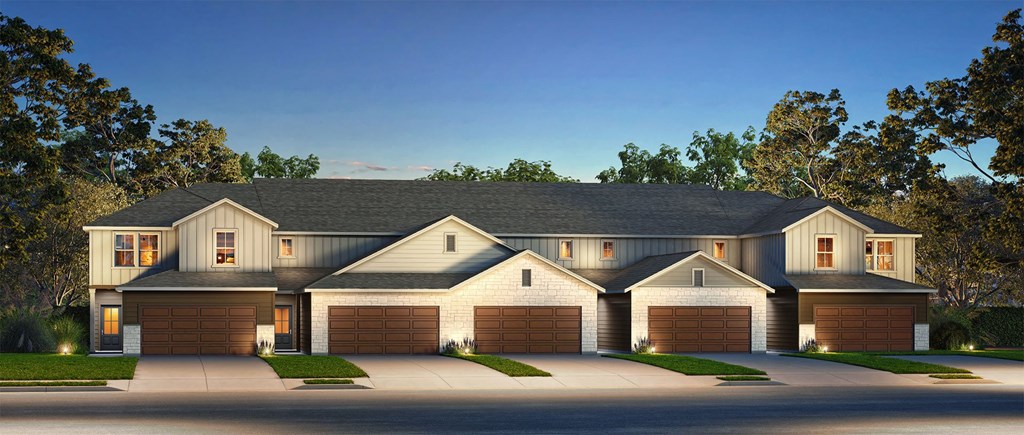 A large, two-story house with a garage on each floor.