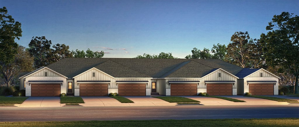 A large house with a grey roof and four garages.