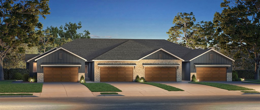 A large house with a grey roof and four garages.