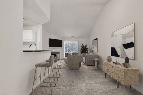 A modern living room with a grey carpet and furniture.