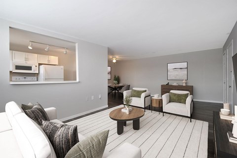 A modern living room with a white sofa set and a coffee table.