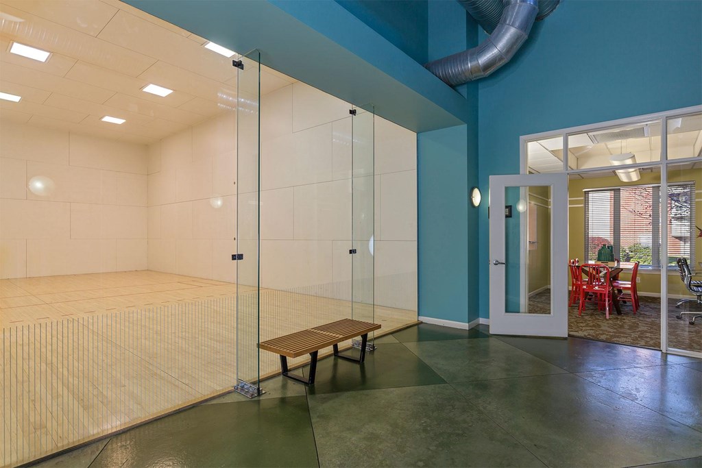 A room with a glass wall and a bench.