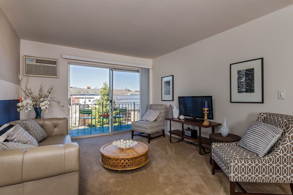 A living room with a couch, chair, and television.