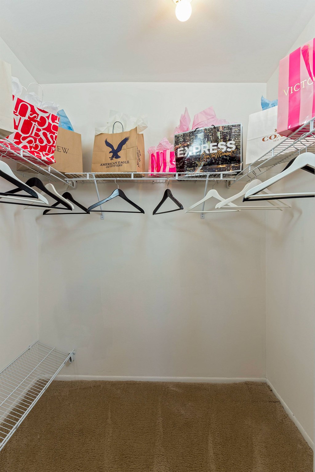 A white wall with a shelf holding bags and a sign that says "EXPRESS".
