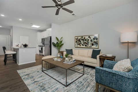 A living room with a blue chair and a coffee table.