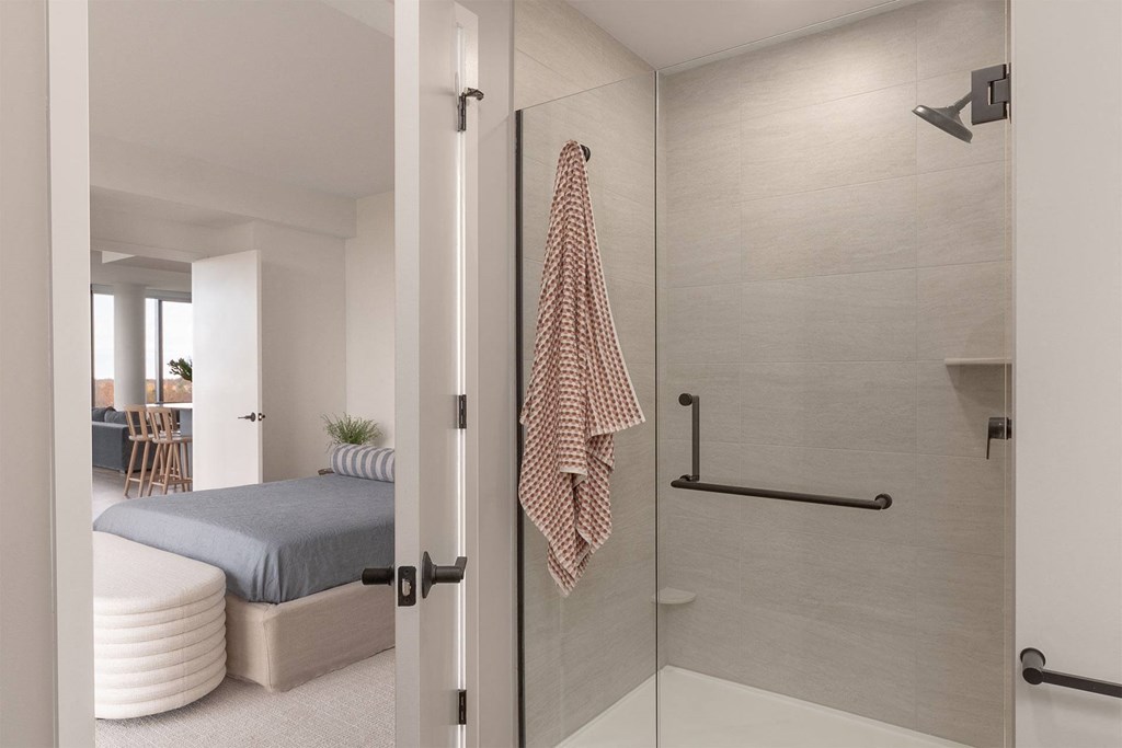A bathroom with a towel hanging on the door.