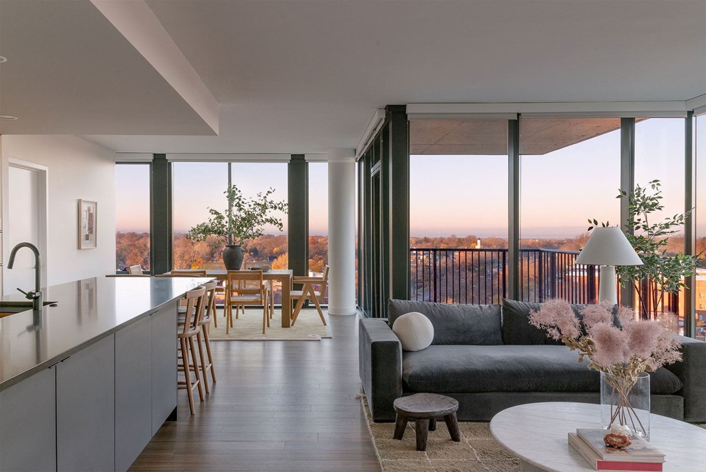 A modern kitchen with a dining table and chairs.