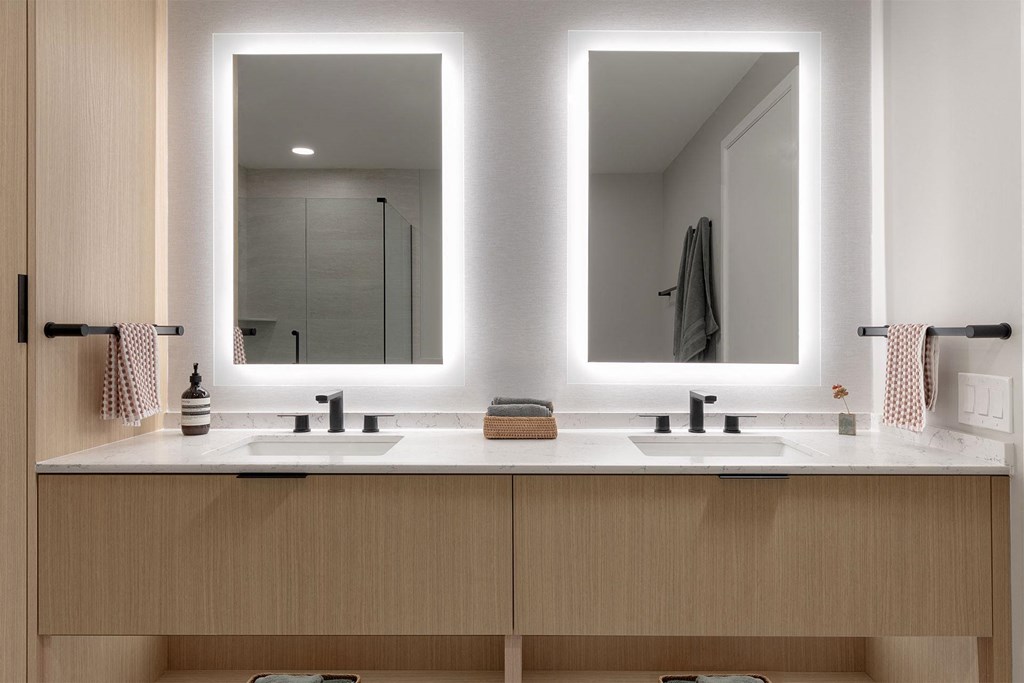 A bathroom with two sinks and two mirrors.
